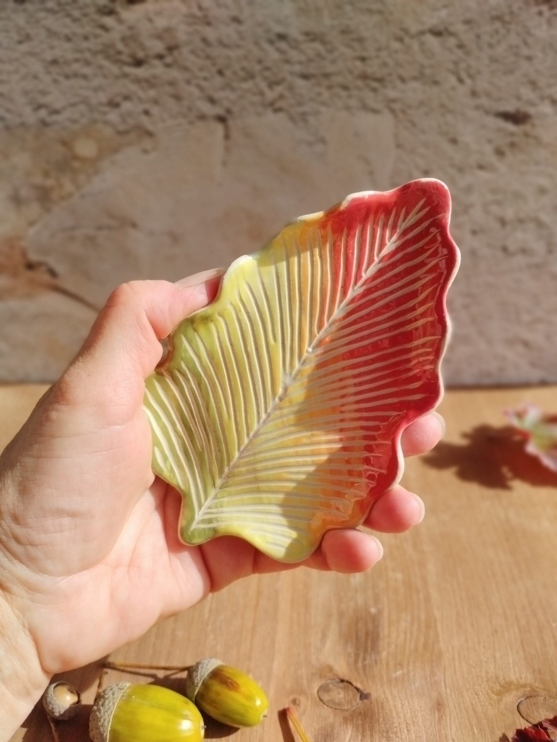 Coupelle à bijoux en céramique artisanale, en forme de feuille de chêne. Couleurs en dégradé rouge, jaune, vert. Motif de nervures gravées