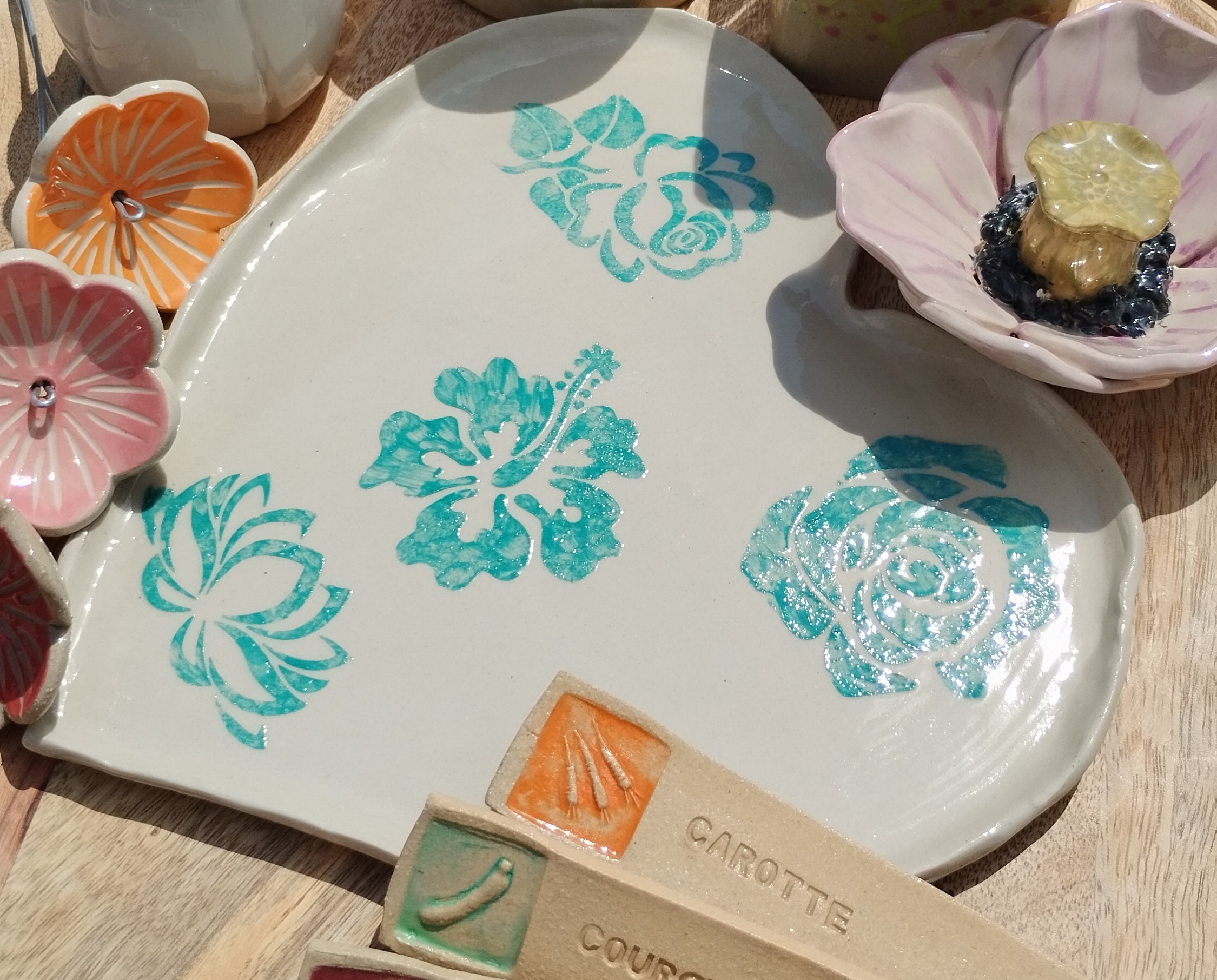Céramiques artisanales variées, assiette, fleur, étiquettes de jardin...